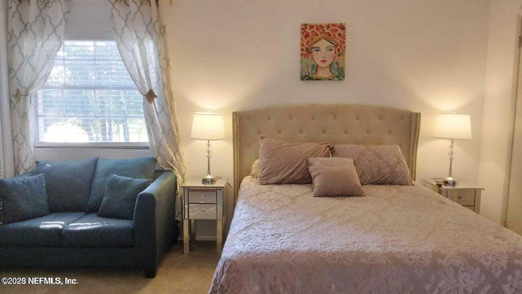9901 Regency Square Boulevard, Unit 90 Jacksonville, FL 32225 - Photo 18 of 27 a bed room with a bed and a couch