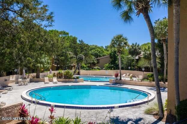 9901 Regency Square Boulevard, Unit 90 Jacksonville, FL 32225 - Photo 24 of 27 a view of a swimming pool with a patio
