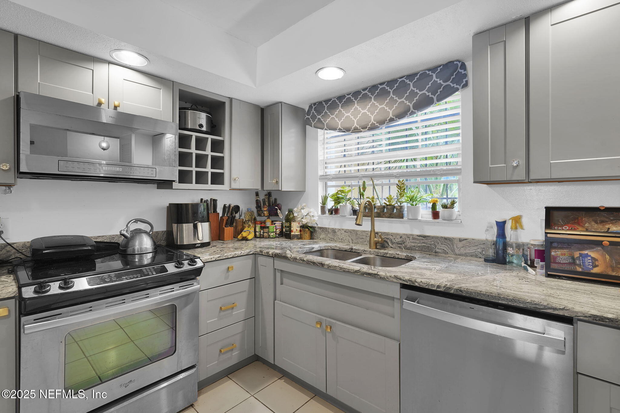 9901 Regency Square Boulevard, Unit 90 Jacksonville, FL 32225 - Photo 3 of 27 a kitchen with stainless steel appliances granite countertop a sink a window and cabinets