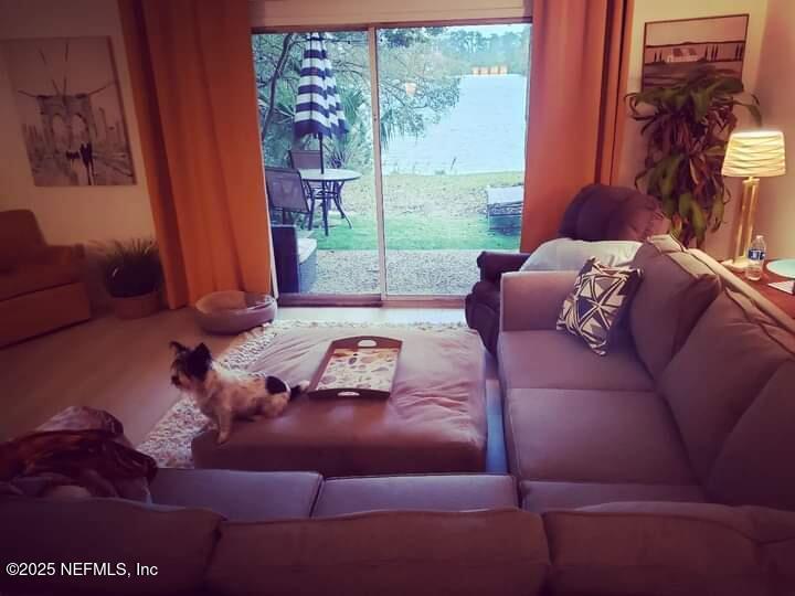 9901 Regency Square Boulevard, Unit 90 Jacksonville, FL 32225 - Photo 8 of 27 a living room with furniture and a floor to ceiling window
