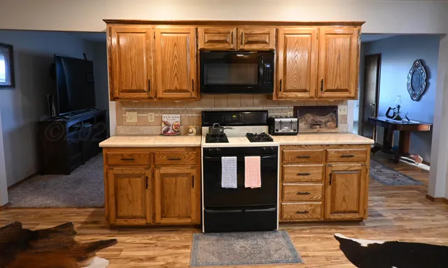 a kitchen with stainless steel appliances granite countertop a stove and a microwave