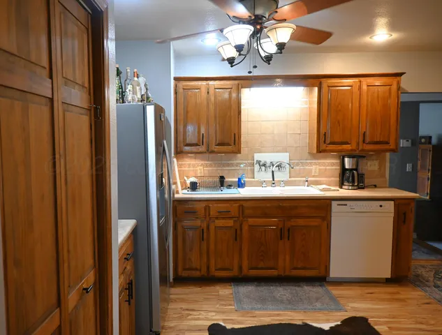 a large kitchen with a large window appliances and cabinets