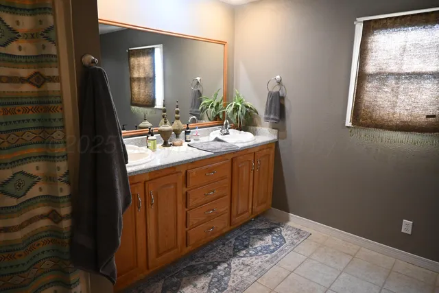 a bathroom with a double vanity sink and a mirror