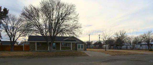 a front view of a house with a trees