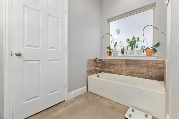 a bath tub sitting next to a white sink and vanity