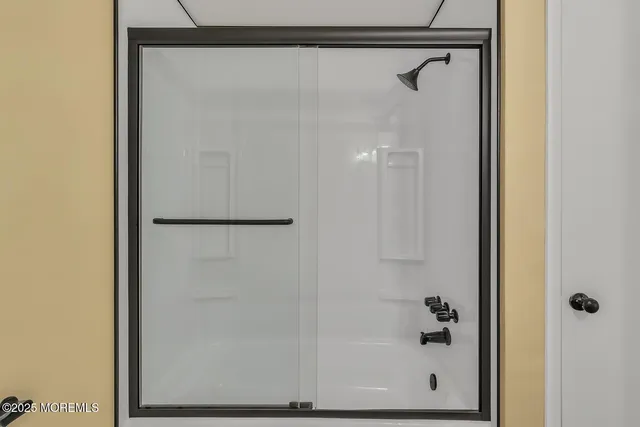a bathroom with a glass shower door
