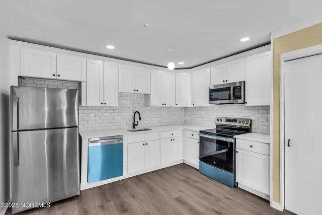 a kitchen with a refrigerator stove and sink