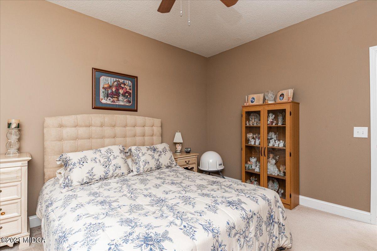 425 Charles Johnson Road Forsyth, GA 31029 - Photo 22 of 33 a bedroom with a bed and a book shelf