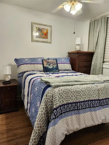 a bed sitting in a bedroom next to a window with a chandelier