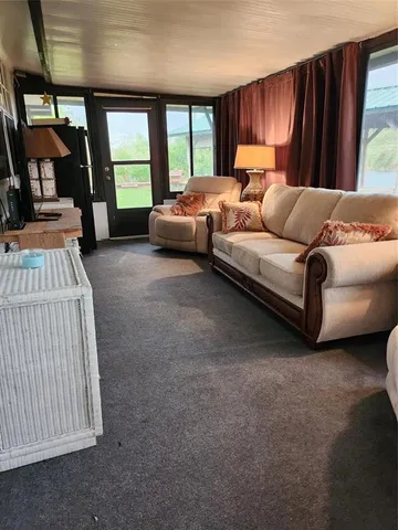 a bedroom with a bed couch and a window