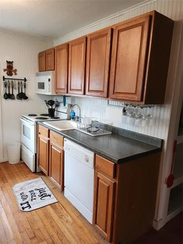 a kitchen with a sink stove and microwave