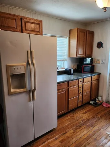 a kitchen with stainless steel appliances granite countertop a refrigerator a sink and dishwasher