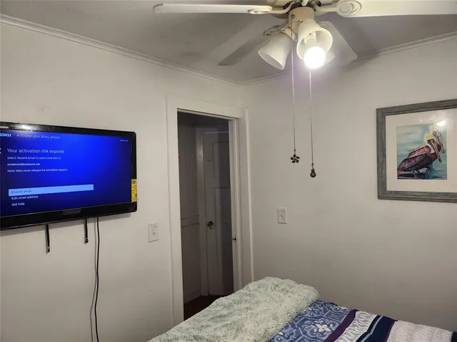 a bedroom with a bed and a mirror