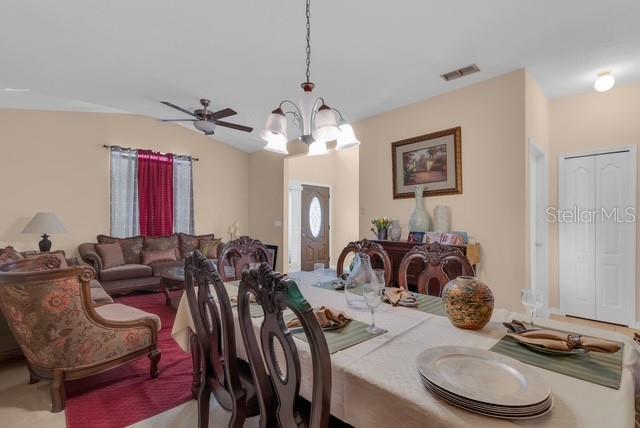 5120 Shale Ridge Trail Orlando, FL 32818 - Photo 3 of 15 a view of a dining room with furniture and chandelier