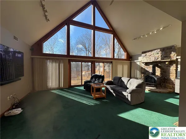 a living room with furniture and a floor to ceiling window
