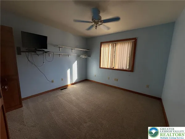a view of an empty room with a window