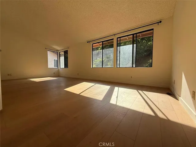 a view of an empty room with windows