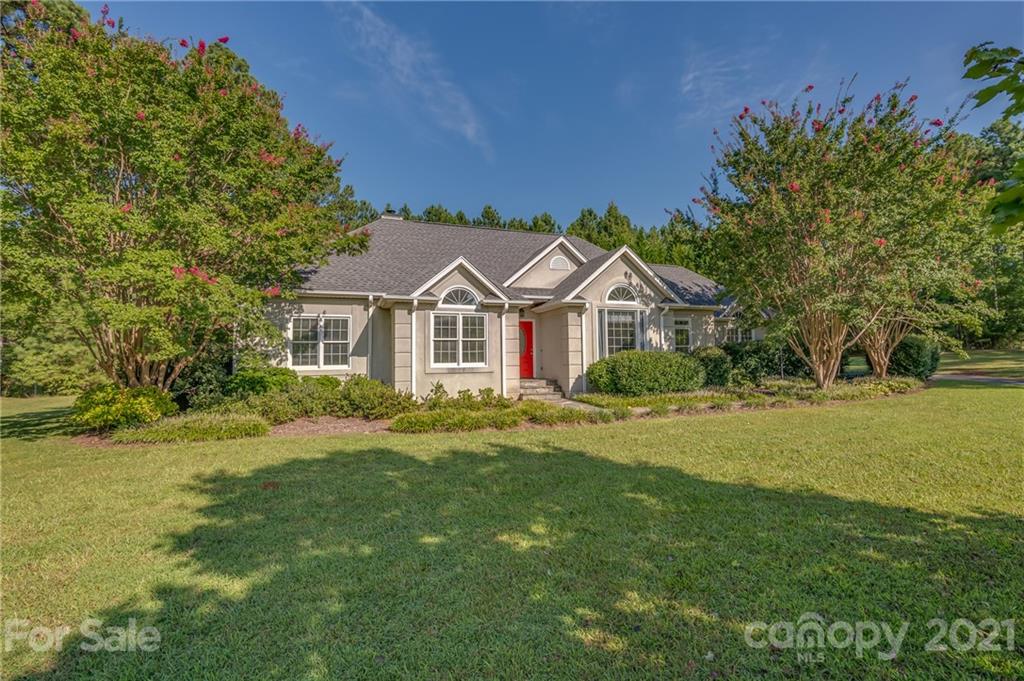 120 Pleasant Hill Road Landrum, SC 29356 - Photo 1 of 25 a view of a white house with a big yard and large trees