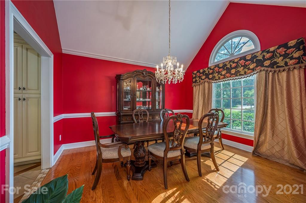 120 Pleasant Hill Road Landrum, SC 29356 - Photo 11 of 25 a view of a dining room with furniture a chandelier and wooden floor