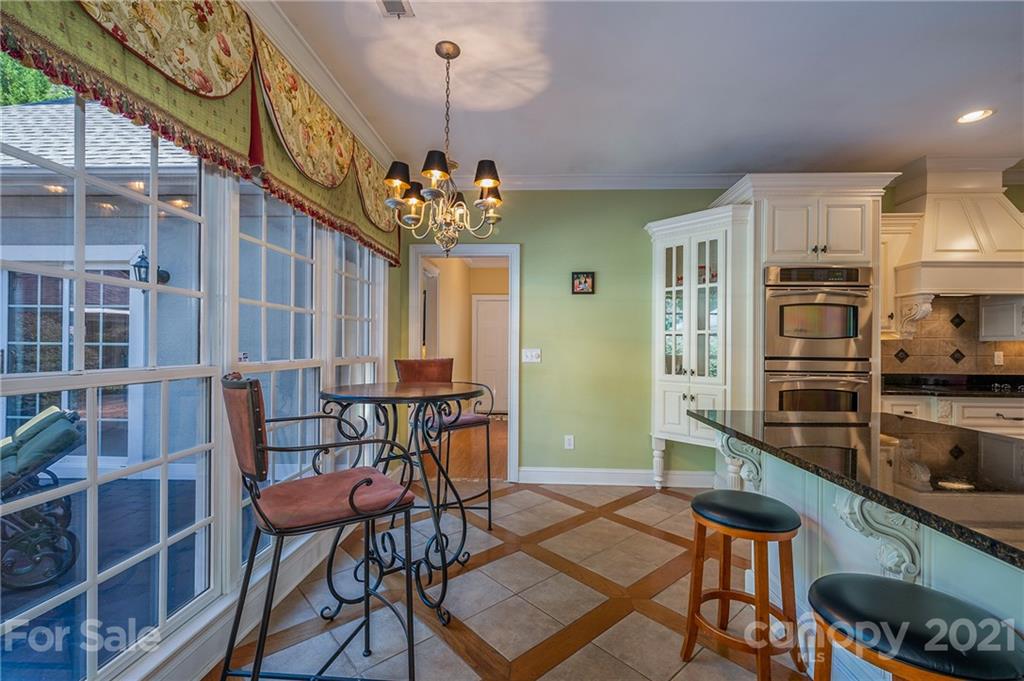 120 Pleasant Hill Road Landrum, SC 29356 - Photo 14 of 25 a view of a dining room with furniture and a chandelier