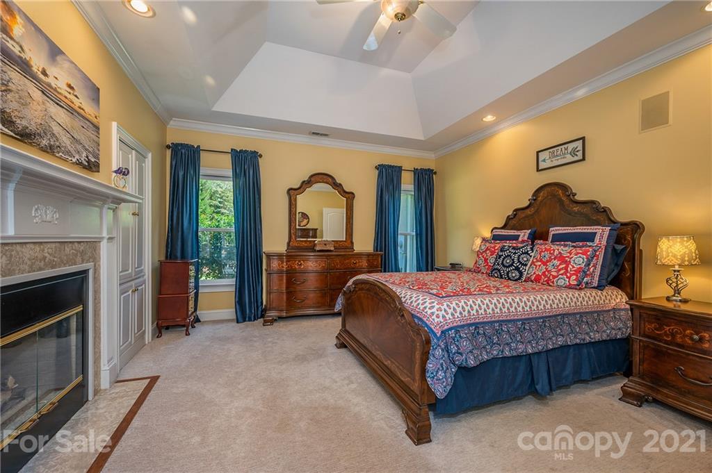 120 Pleasant Hill Road Landrum, SC 29356 - Photo 15 of 25 a bedroom with a bed and a fireplace