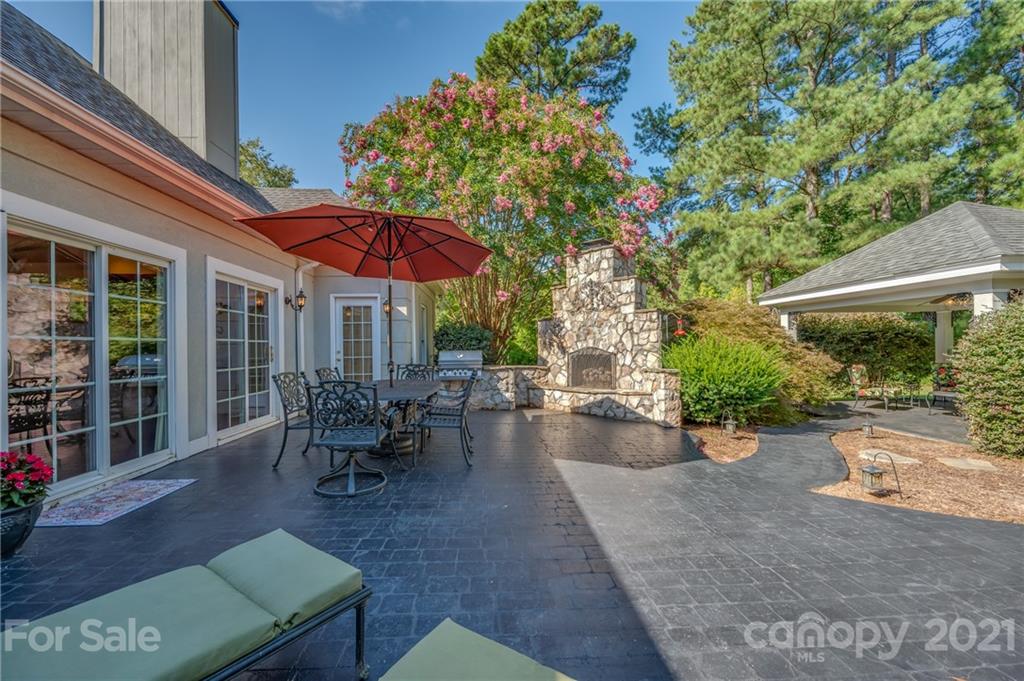 120 Pleasant Hill Road Landrum, SC 29356 - Photo 23 of 25 a view of a backyard with a patio and fire pit