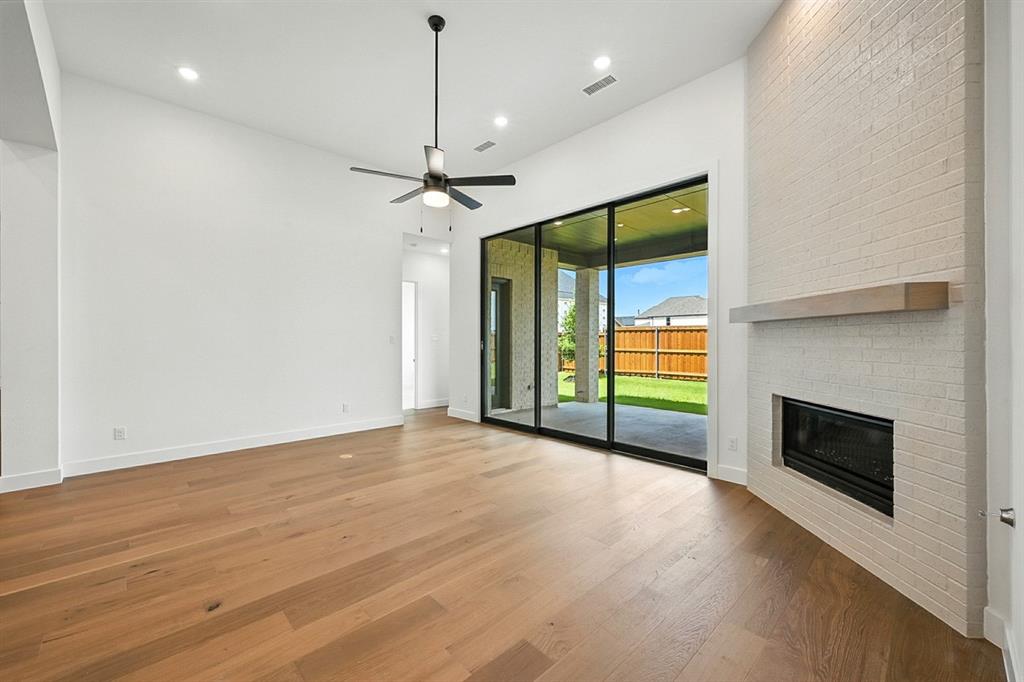 4013 Trellis Drive Prosper, TX 75078 - Photo 11 of 35 an empty room with windows and fireplace