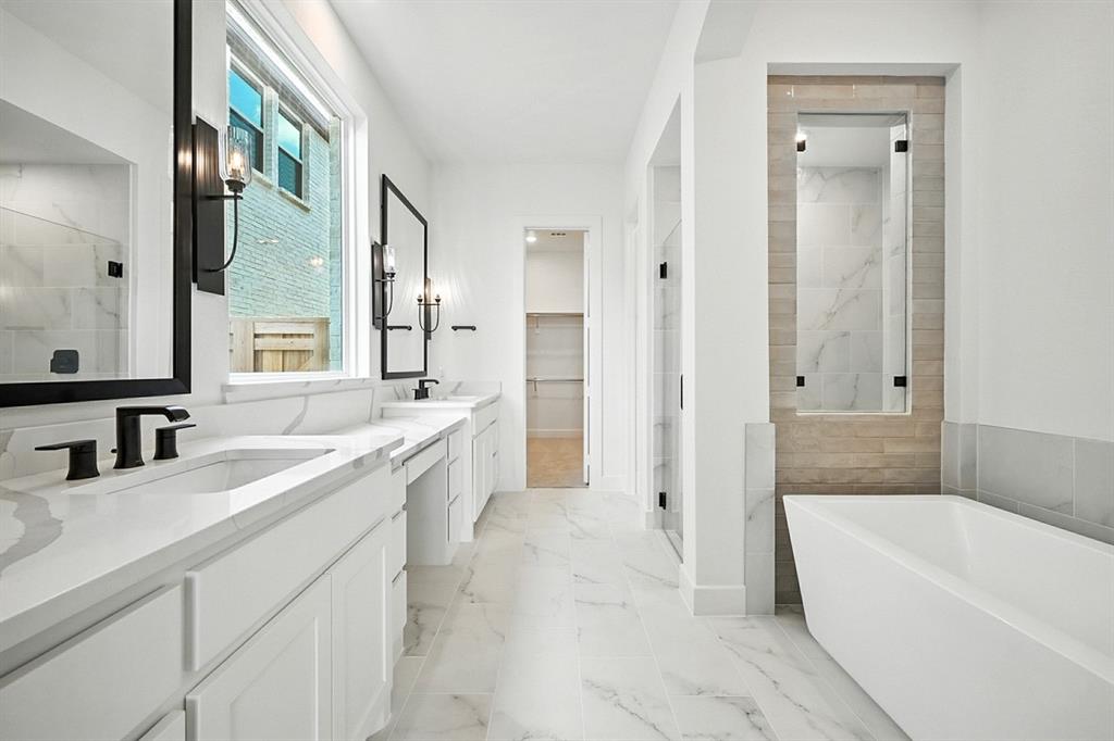 4013 Trellis Drive Prosper, TX 75078 - Photo 14 of 35 a bathroom with a granite countertop double vanity sink a bathtub and mirror