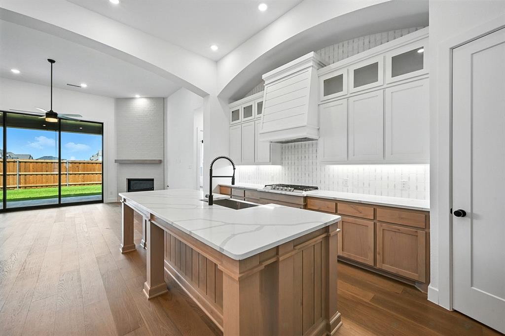 4013 Trellis Drive Prosper, TX 75078 - Photo 2 of 35 a kitchen that has a sink and a stove in it