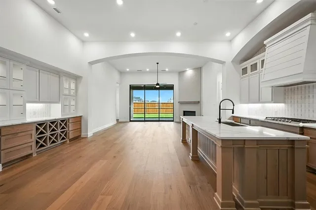 a kitchen with stainless steel appliances granite countertop a sink stove and wooden cabinets