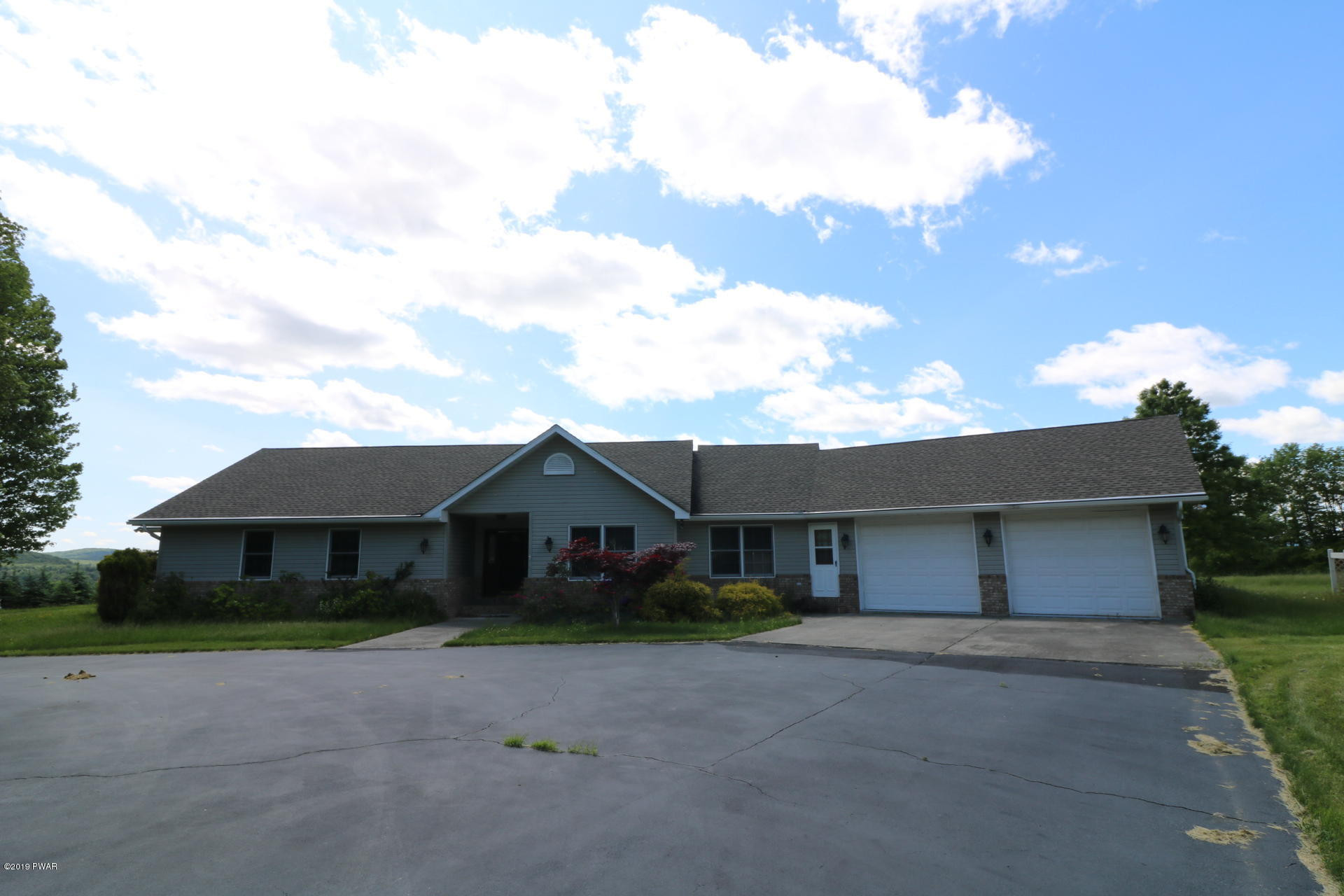 53 Savitz Road Lake Ariel, PA 18436 - Photo 3 of 53 a front view of a house with a yard and garage