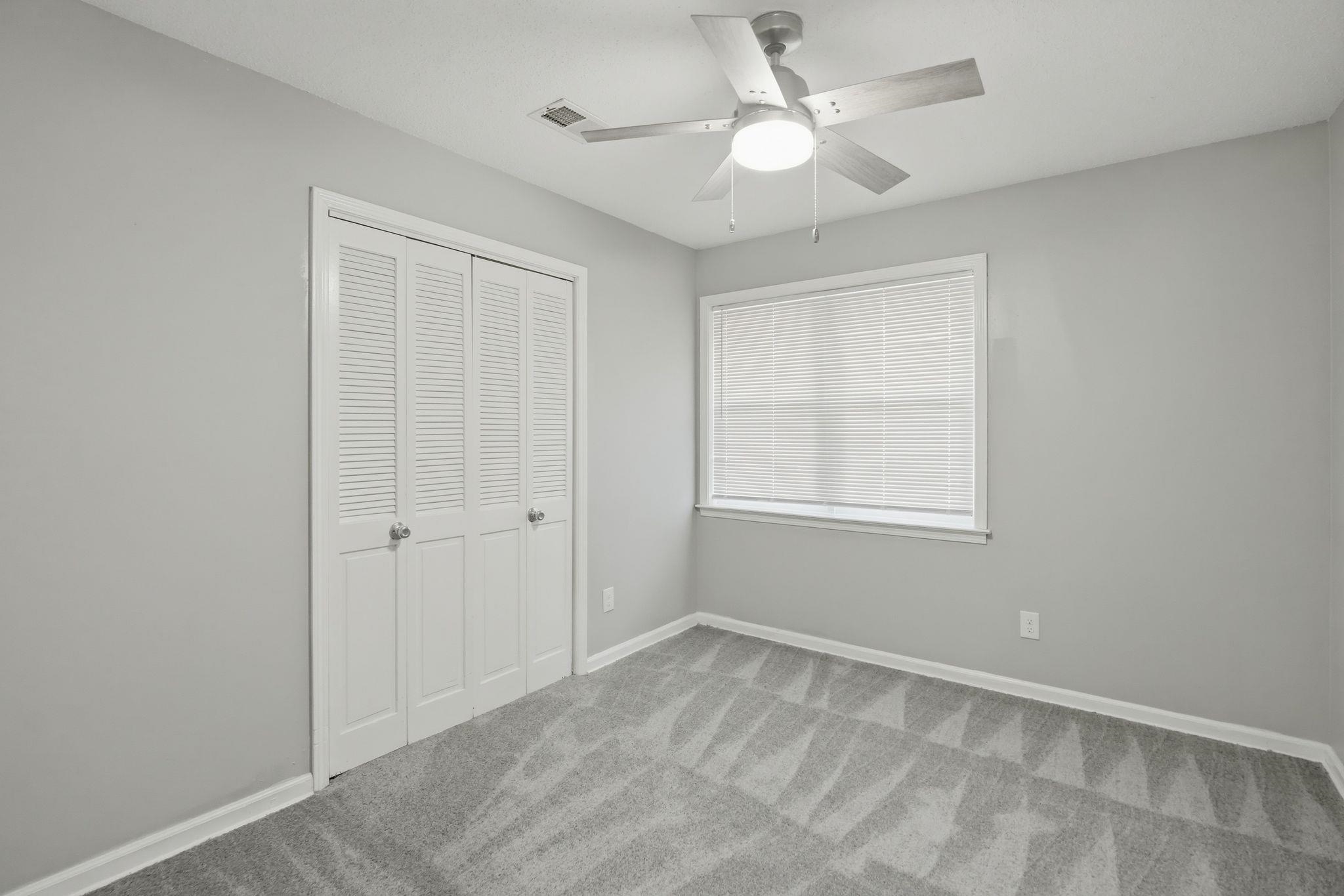 4686 Gill Road Memphis, TN 38109 - Photo 26 of 32 Bedroom featuring light gray walls, gray patterned carpet, and a ceiling fan with integrated lighting