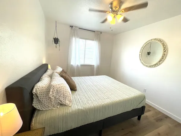 a bedroom with a bed and a chandelier