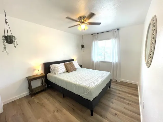 a bathroom with a sink a toilet a mirror a vanity and shower