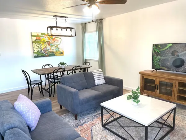a living room with furniture and a fireplace