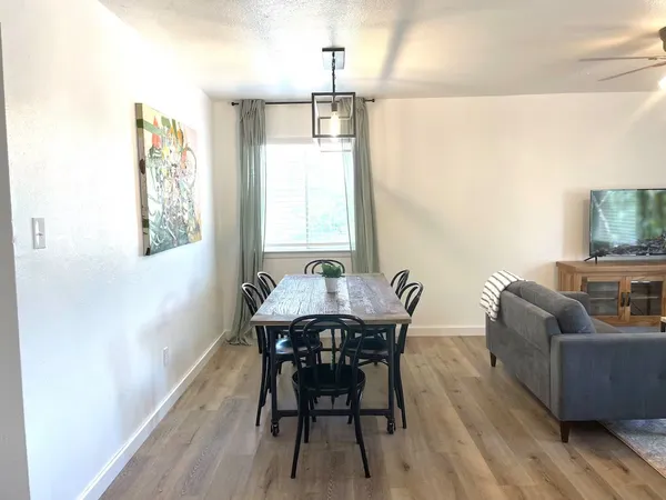 a dining room with furniture and window