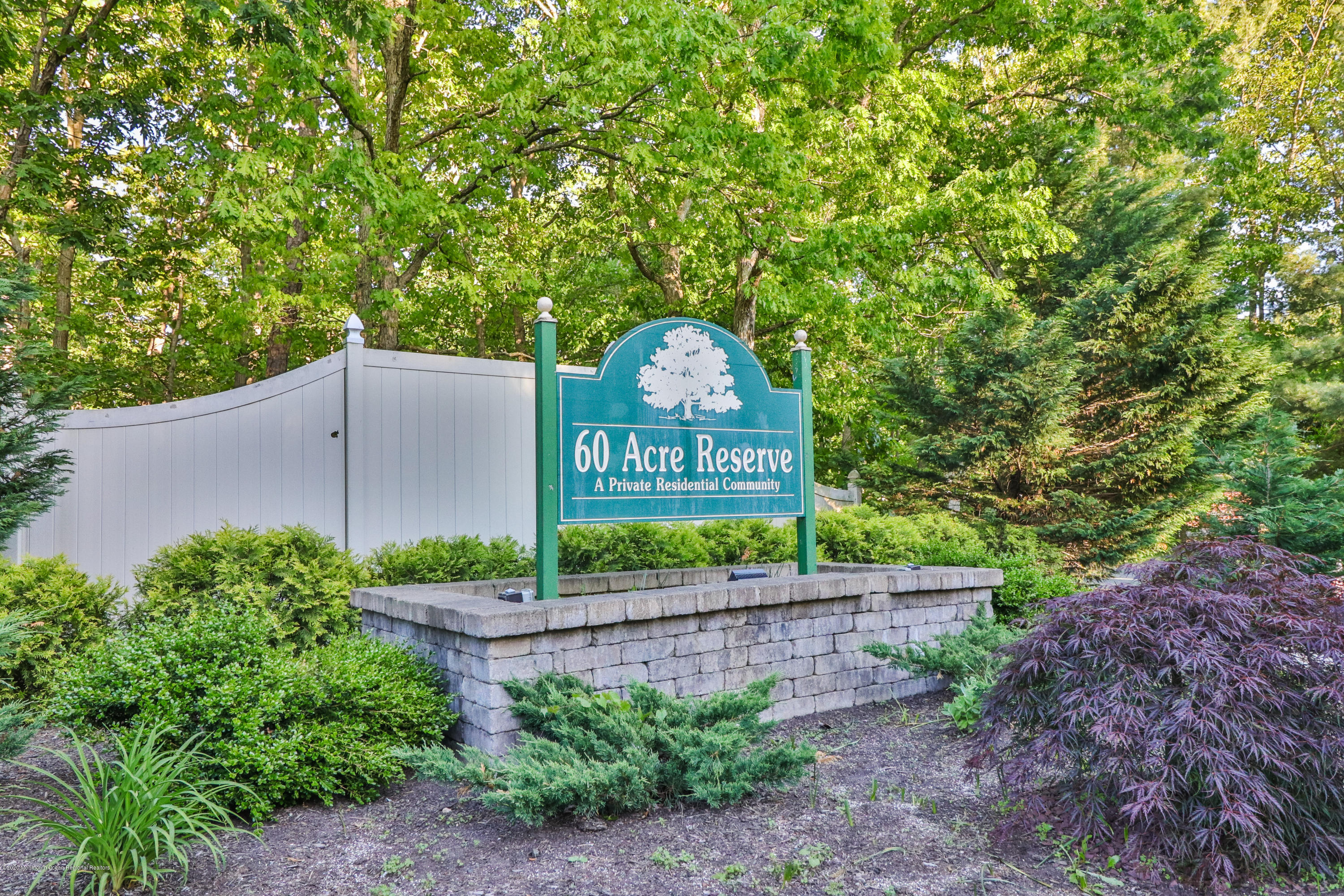 704 Violet Lane Jackson, NJ 08527 - Photo 19 of 20 a sign that is sitting on a wooden fence