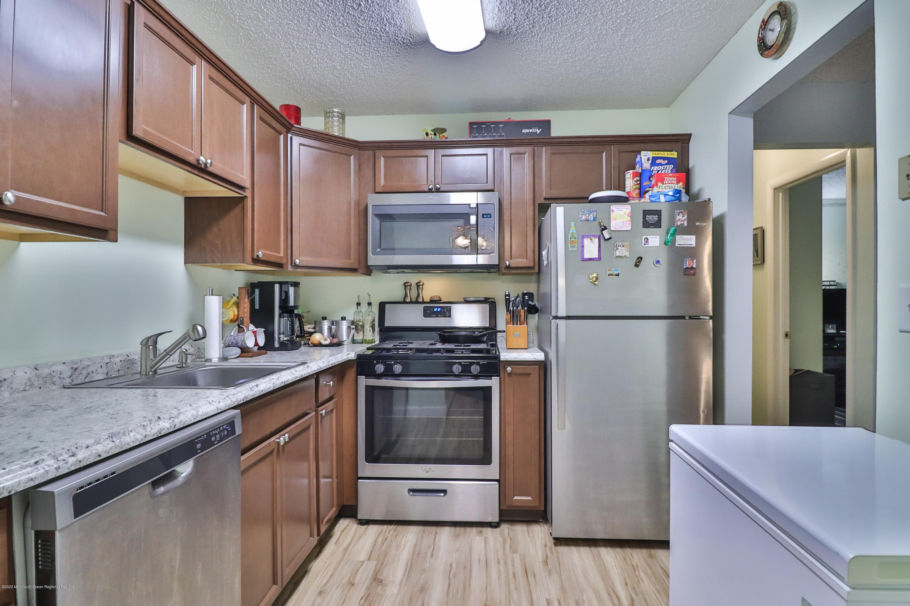 704 Violet Lane Jackson, NJ 08527 - Photo 5 of 20 a kitchen with stainless steel appliances granite countertop a refrigerator sink and stove