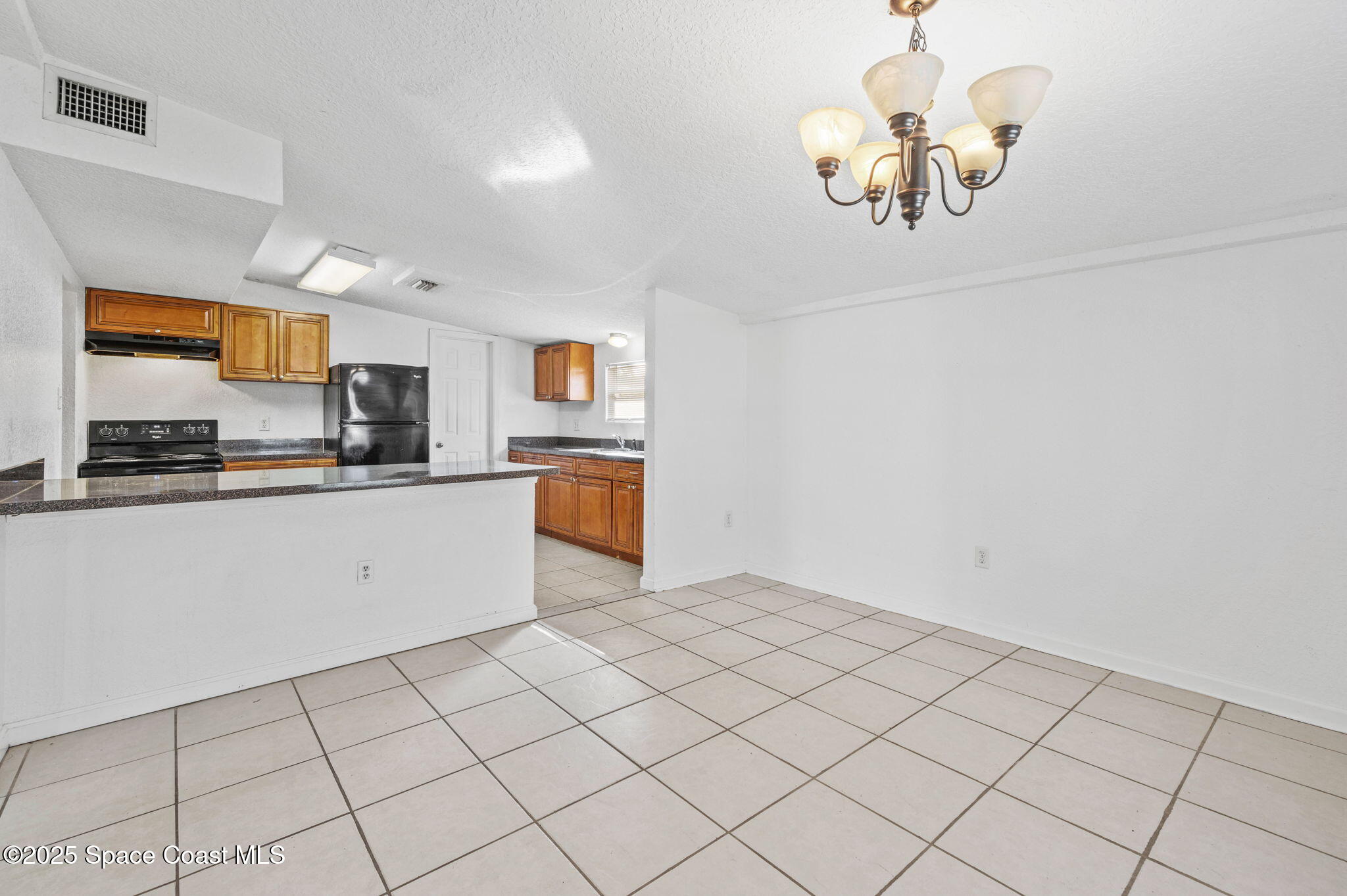 907 Espanola Way Melbourne, FL 32901 - Photo 13 of 31 a kitchen with cabinets a sink and appliances