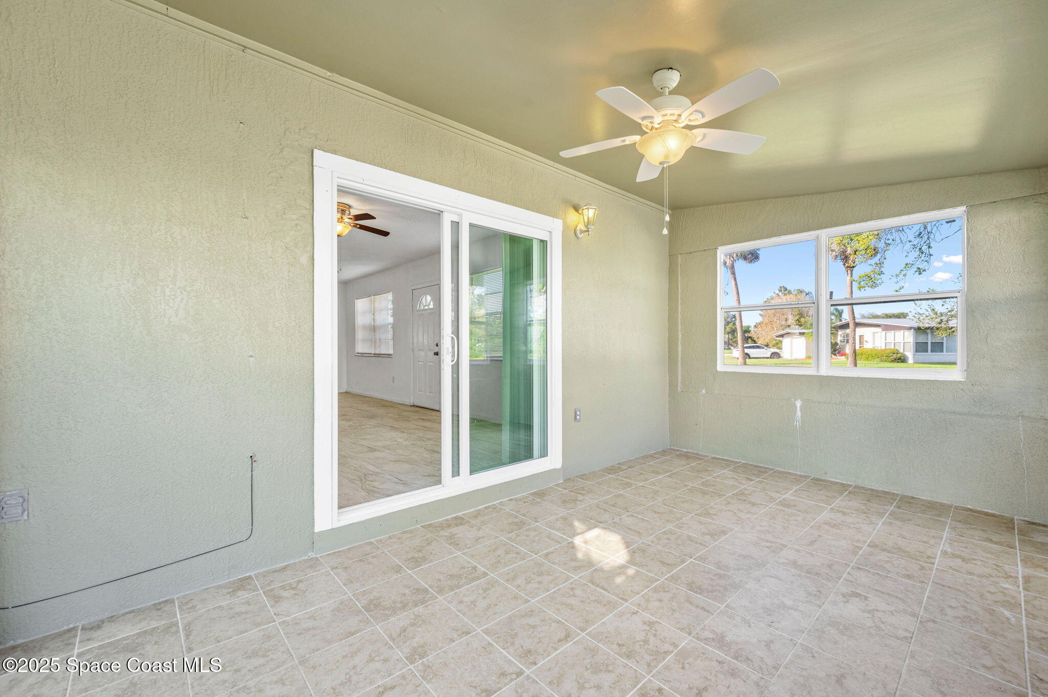 907 Espanola Way Melbourne, FL 32901 - Photo 19 of 31 an empty room with fan and windows