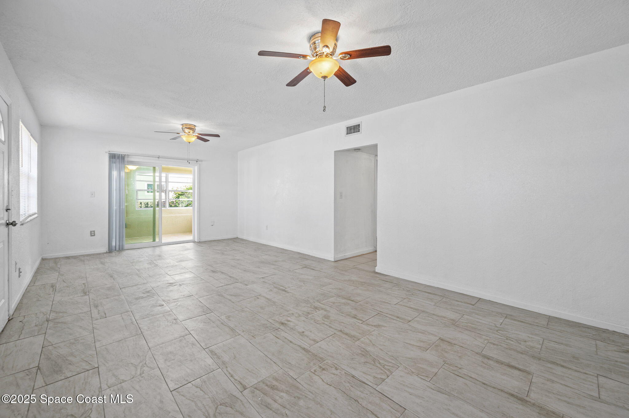 907 Espanola Way Melbourne, FL 32901 - Photo 5 of 31 a view of an empty room with a window