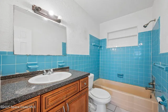 a bathroom with a sink toilet and a mirror