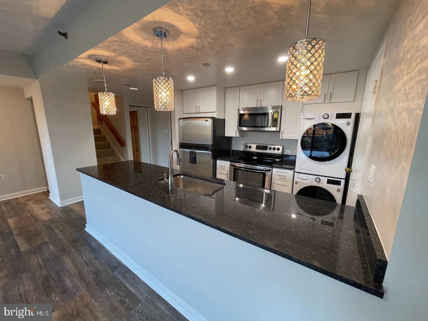 1530 Key Boulevard, Unit 326 Arlington, VA 22209 - Photo 20 of 47 a kitchen with stainless steel appliances granite countertop a sink a stove and a refrigerator