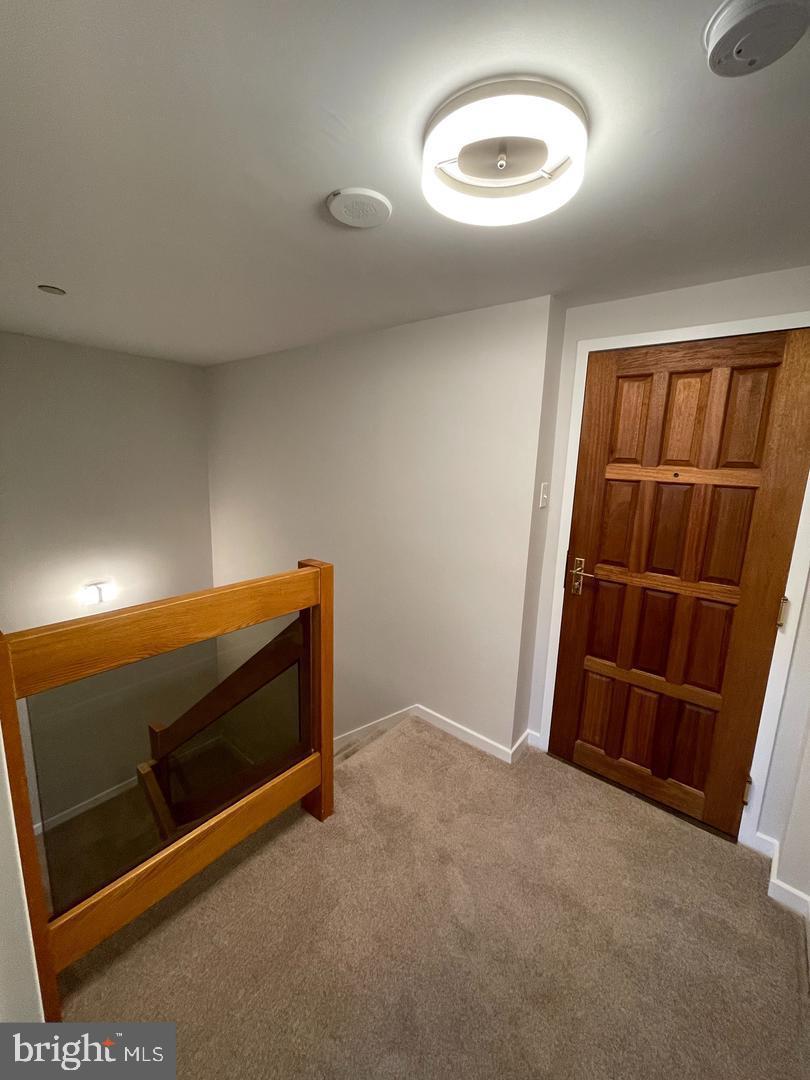 1530 Key Boulevard, Unit 326 Arlington, VA 22209 - Photo 25 of 47 a view of an empty room with wooden floor and a window