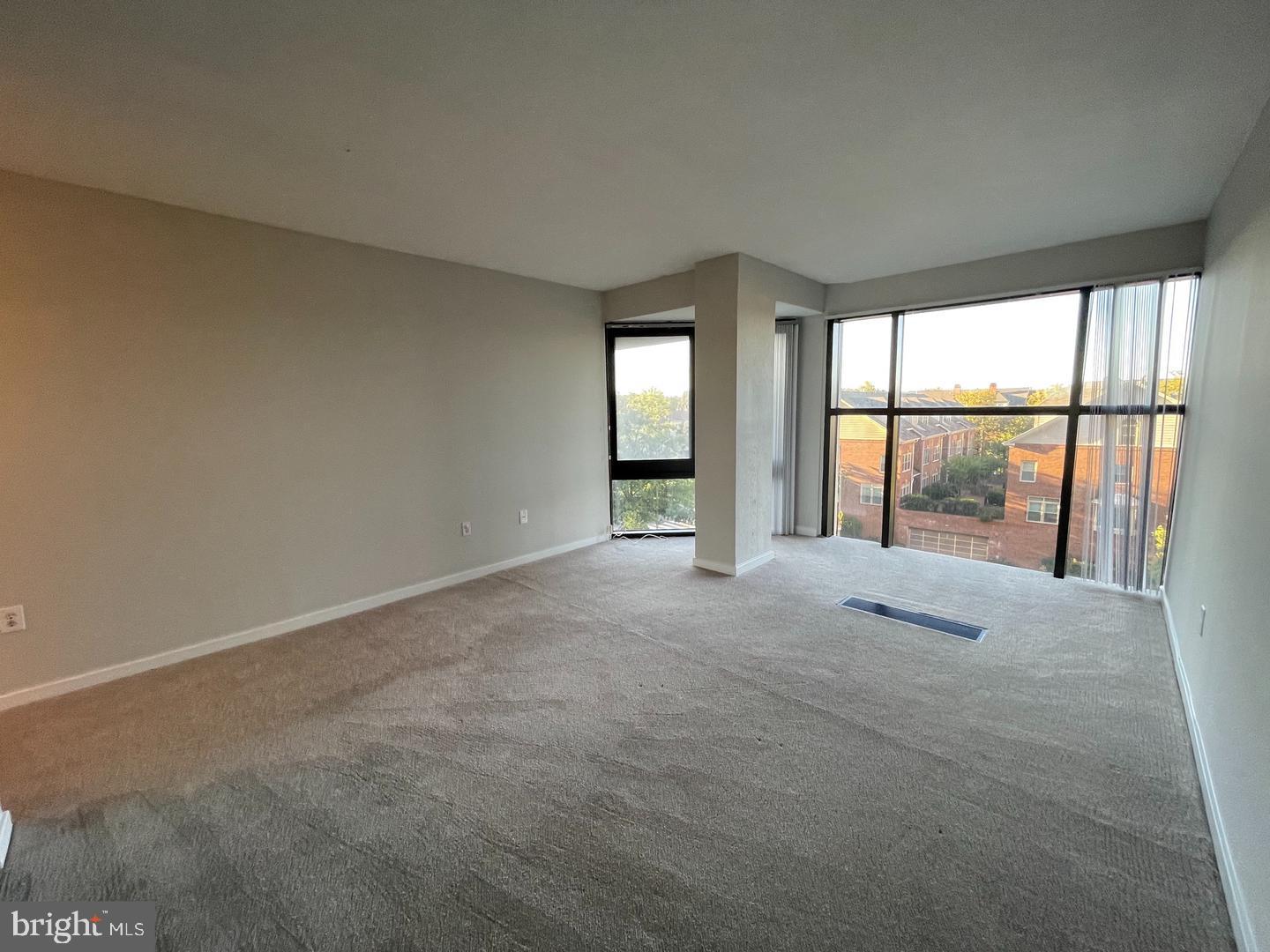 1530 Key Boulevard, Unit 326 Arlington, VA 22209 - Photo 29 of 47 an empty room with large windows
