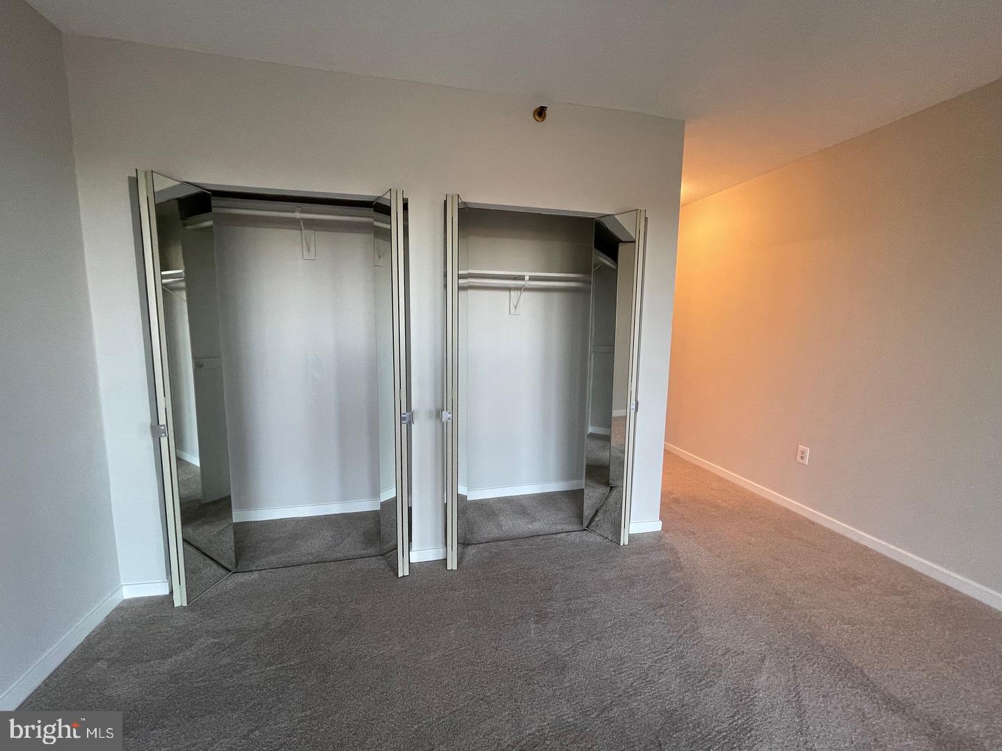 1530 Key Boulevard, Unit 326 Arlington, VA 22209 - Photo 30 of 47 an empty room with closet and wooden door