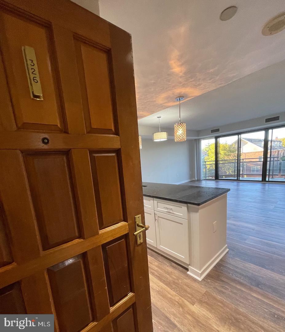 1530 Key Boulevard, Unit 326 Arlington, VA 22209 - Photo 32 of 47 a kitchen with granite countertop a stove and a refrigerator