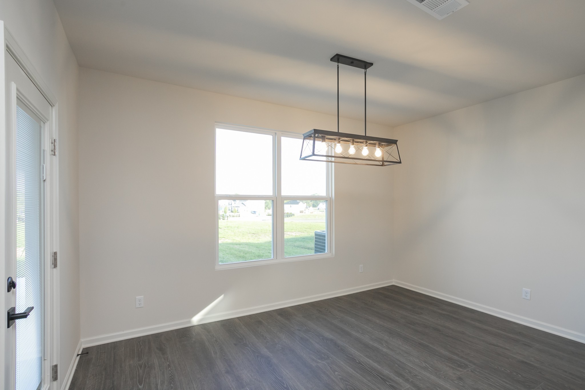 940 Pleasant Ridge Run Mount Juliet, TN 37122 - Photo 14 of 32 an empty room with wooden floor chandelier and windows