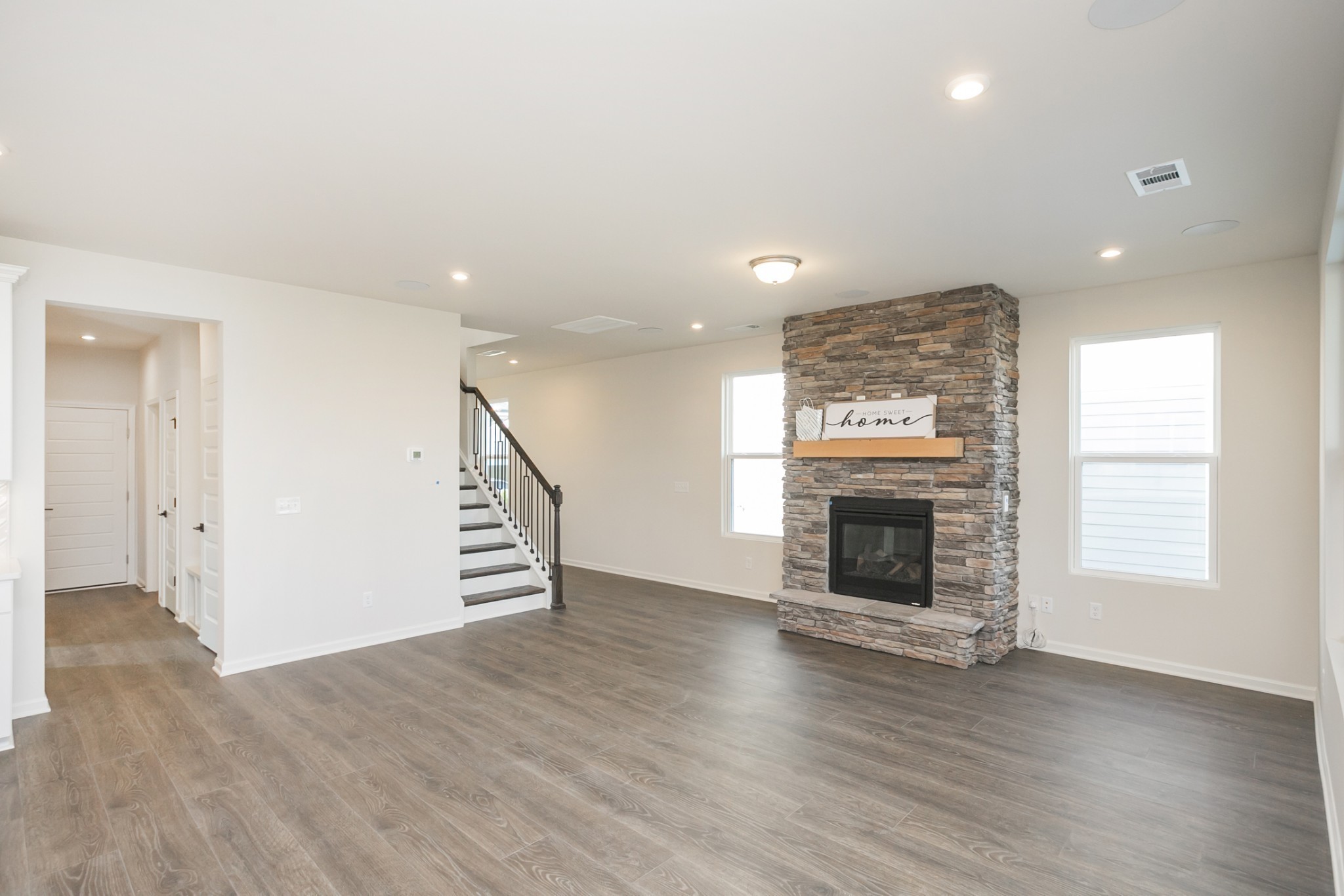 940 Pleasant Ridge Run Mount Juliet, TN 37122 - Photo 16 of 32 an empty room with wooden floor fireplace and windows