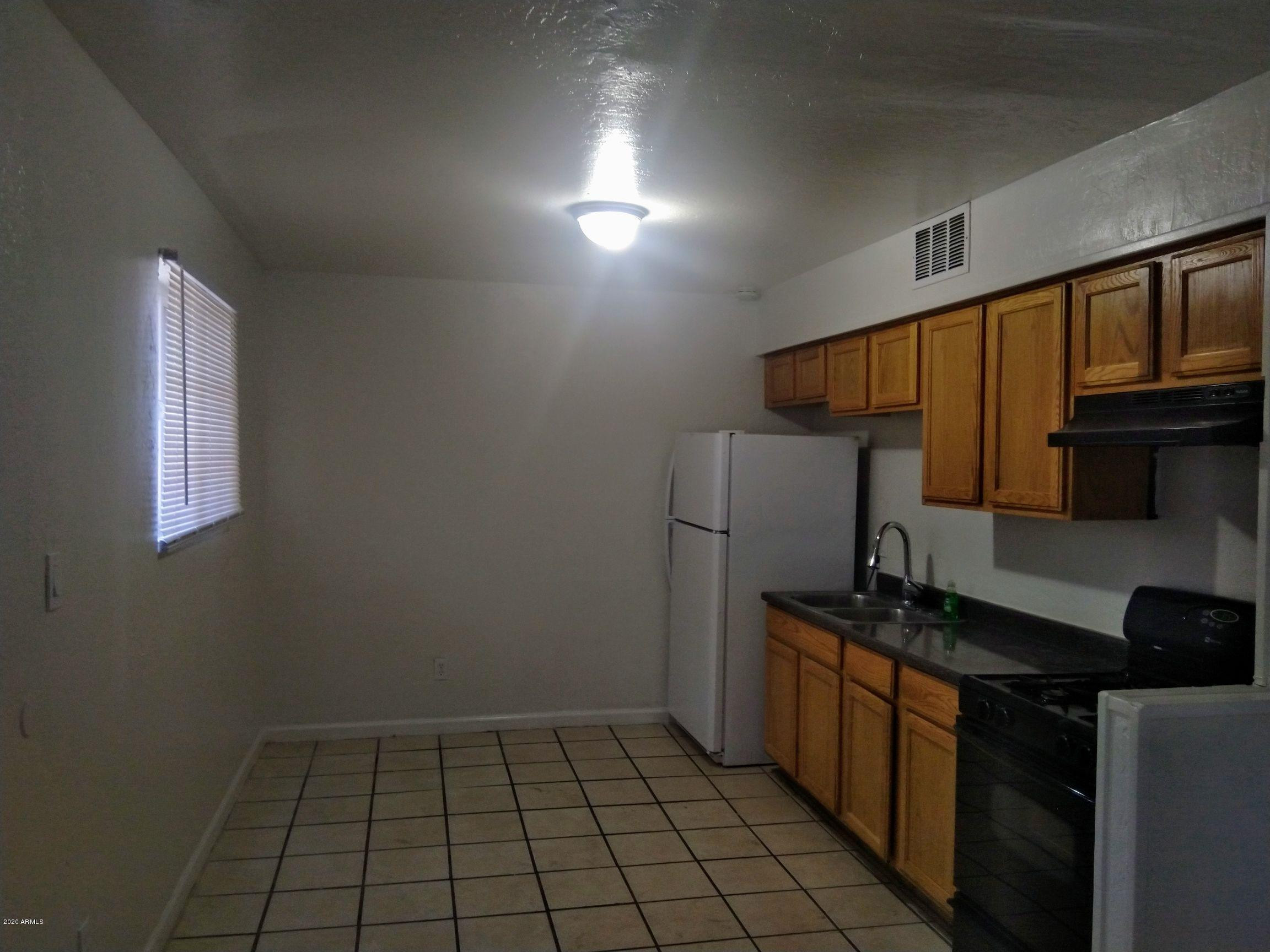 2133 West Adams Street, Unit 3 Phoenix, AZ 85009 - Photo 2 of 10 a kitchen with a sink a stove and cabinets